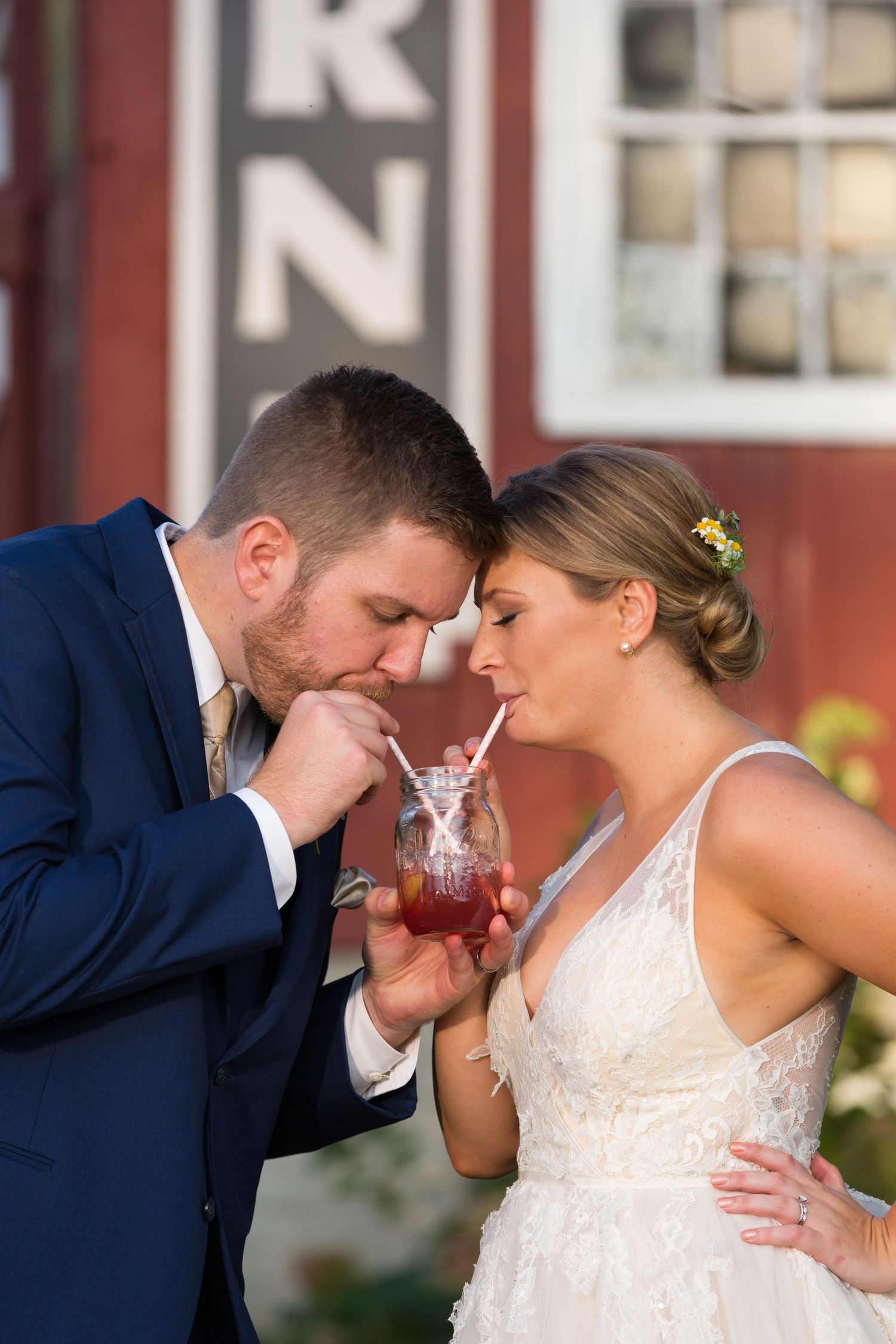 Newlyweds share a cool drink at Mustard Seed Gardens after their ceremony.