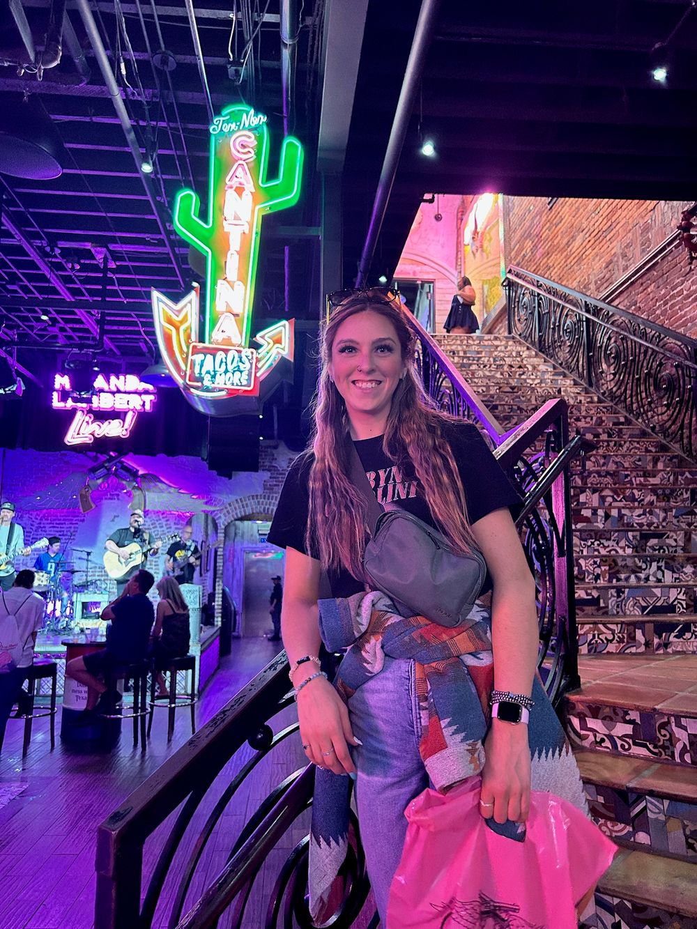 A series of photos showing someone posing at a lively bar or restaurant with neon signs and decorative lighting.