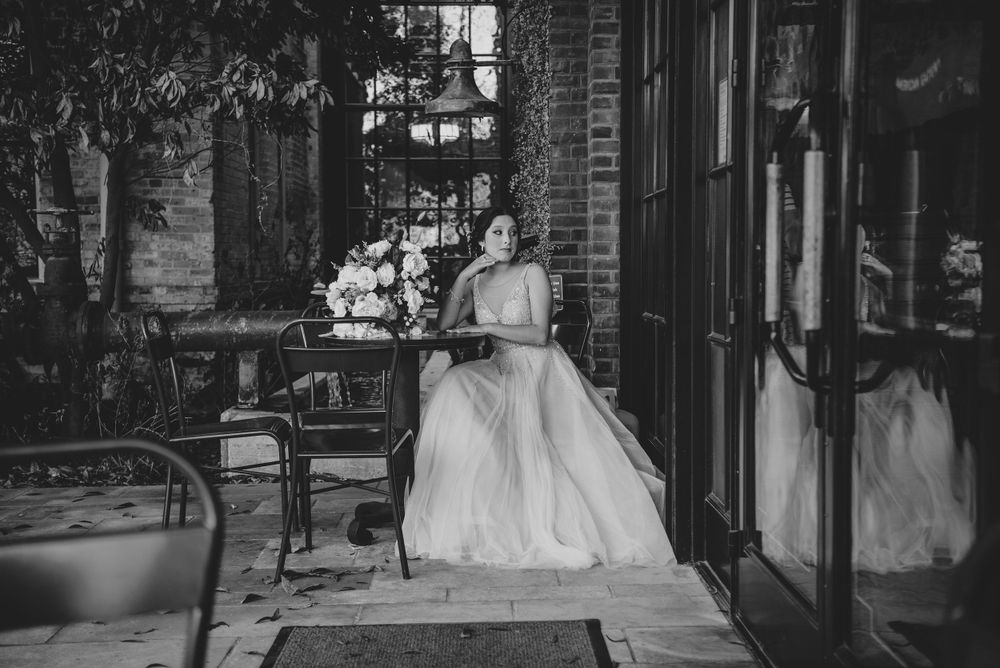 black and white girl sitting down in table. The Pearl. San Antonio, Texas. Wedding photographer