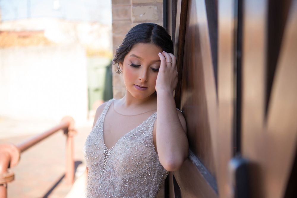 girl leaning on door. looking down The Pearl. San Antonio, Texas. Wedding photographer