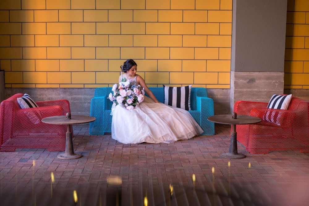 girl sitting on blue couch. yellow wall. The Pearl. San Antonio, Texas. Wedding photographer