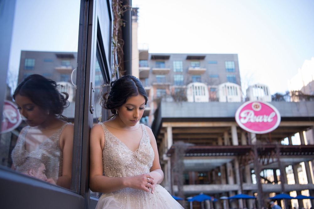 girl looking down her hands. quinceanera. The Pearl. San Antonio, Texas. Wedding photographer
