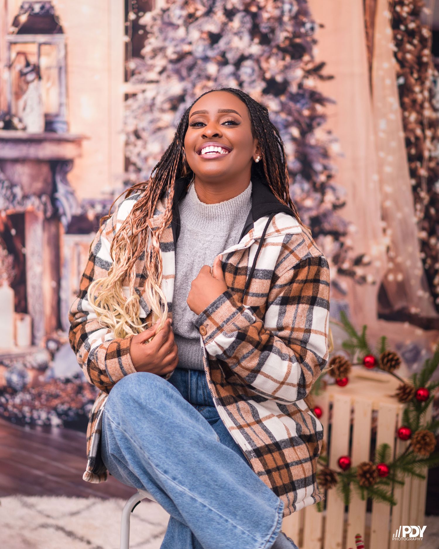 Casual winter style featuring plaid jacket and jeans in festive Christmas setting.