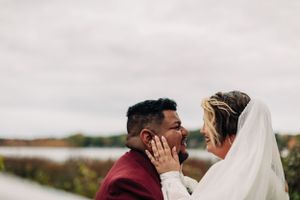 Intimate moment between couple during outdoor wedding portraits.
