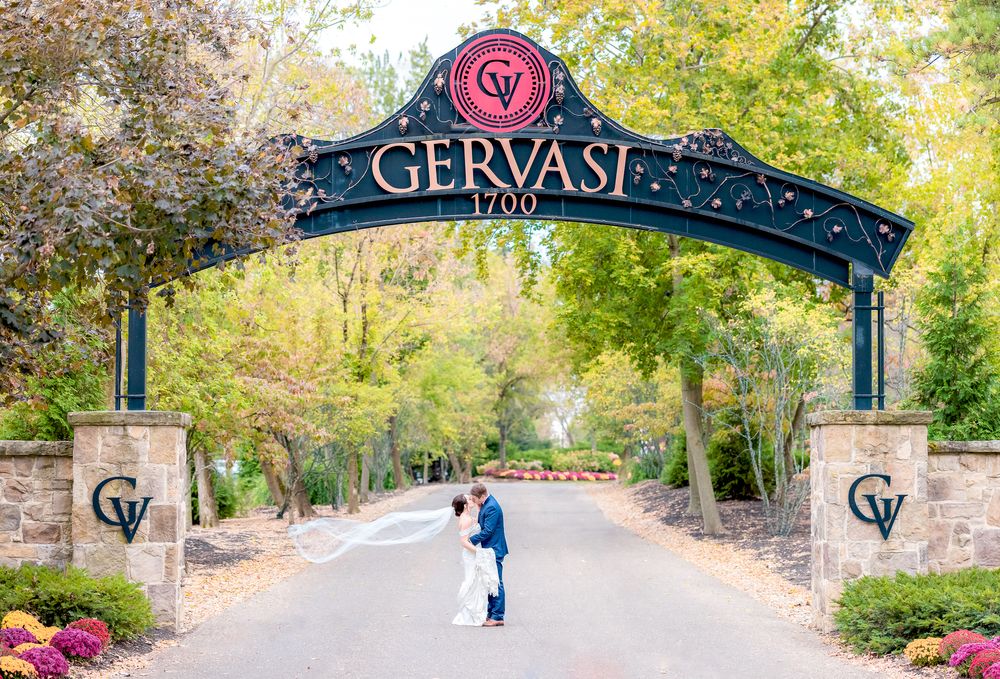 Couple Kissing Under the Gervasi Vineyard Entrance Sign During Wedding at Gervasi Vineyard in Canton, Ohio