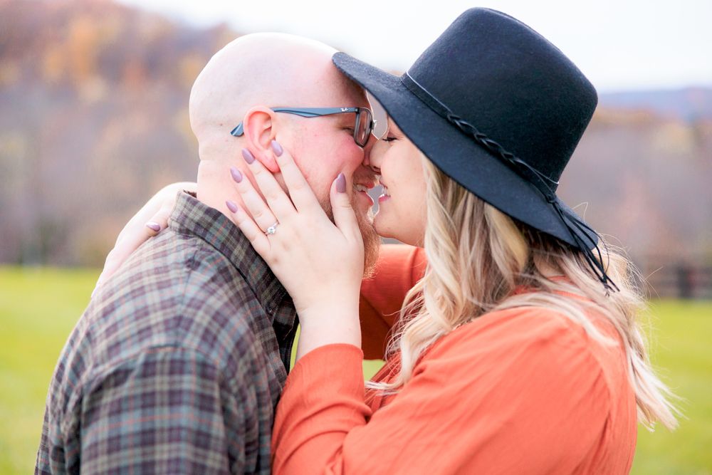 Couple Smiling and Kissing During Engagement Photo Session at Rivercrest Farm in Dover, Ohio
