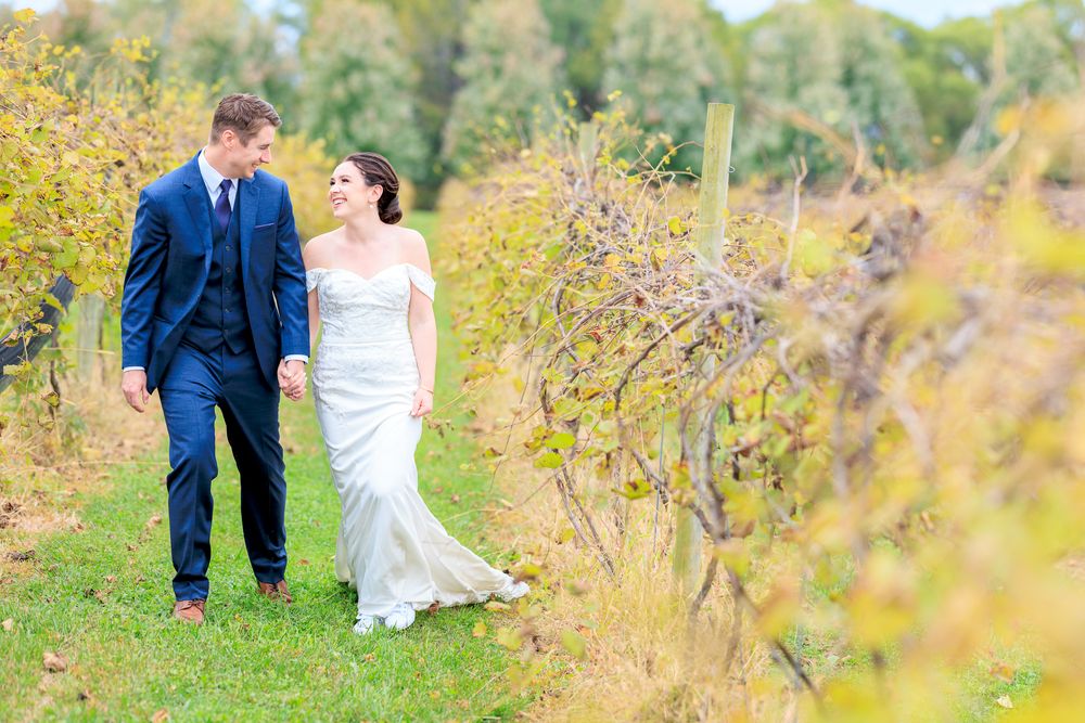 Couple Walking Through Wine Vineyard During Wedding at Gervasi Vineyard in Canton, Ohio