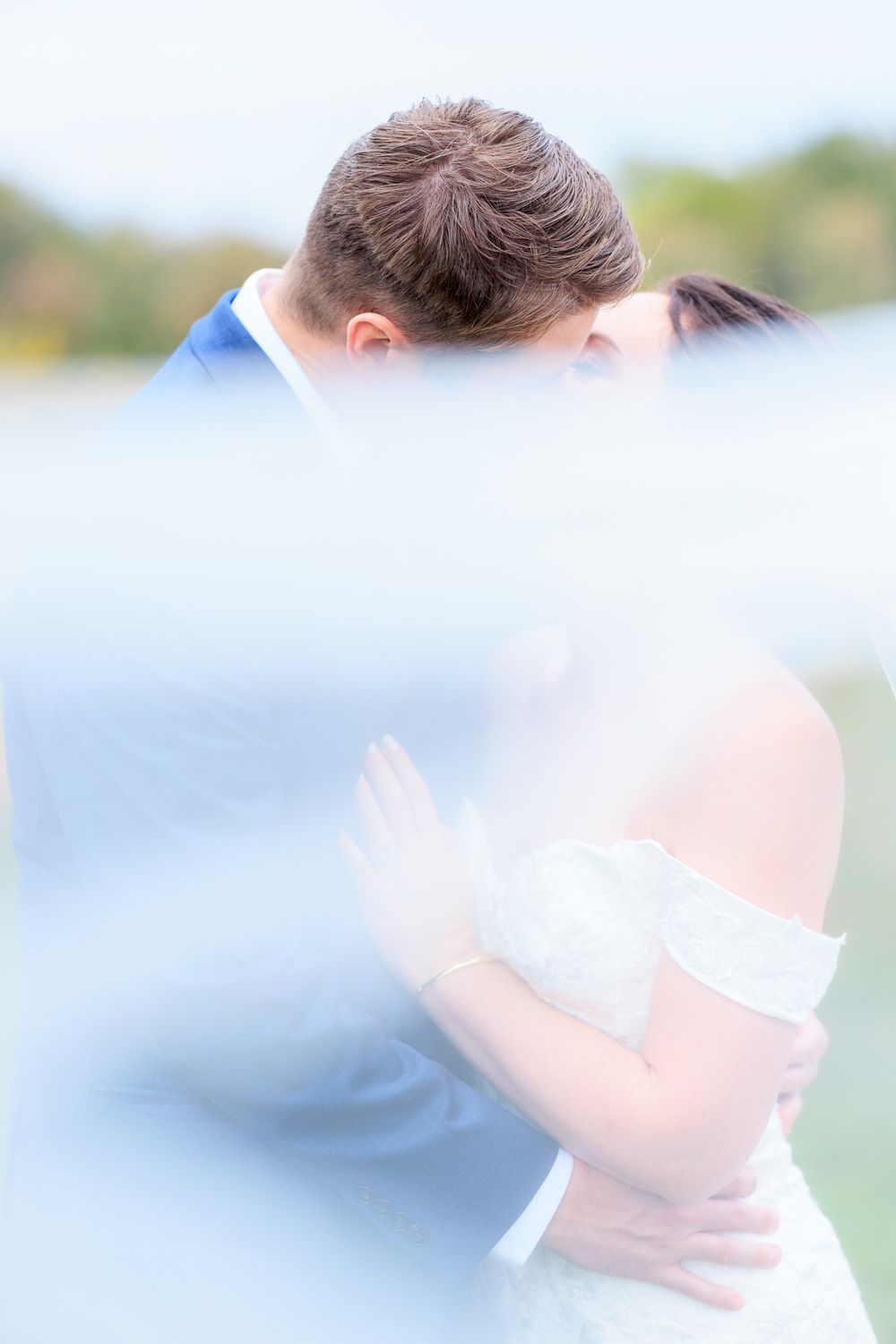 Under The Veil Wedding Portrait of Couple Kissing in Vineyard During Wedding at Gervasi Vineyard in Canton, Ohio