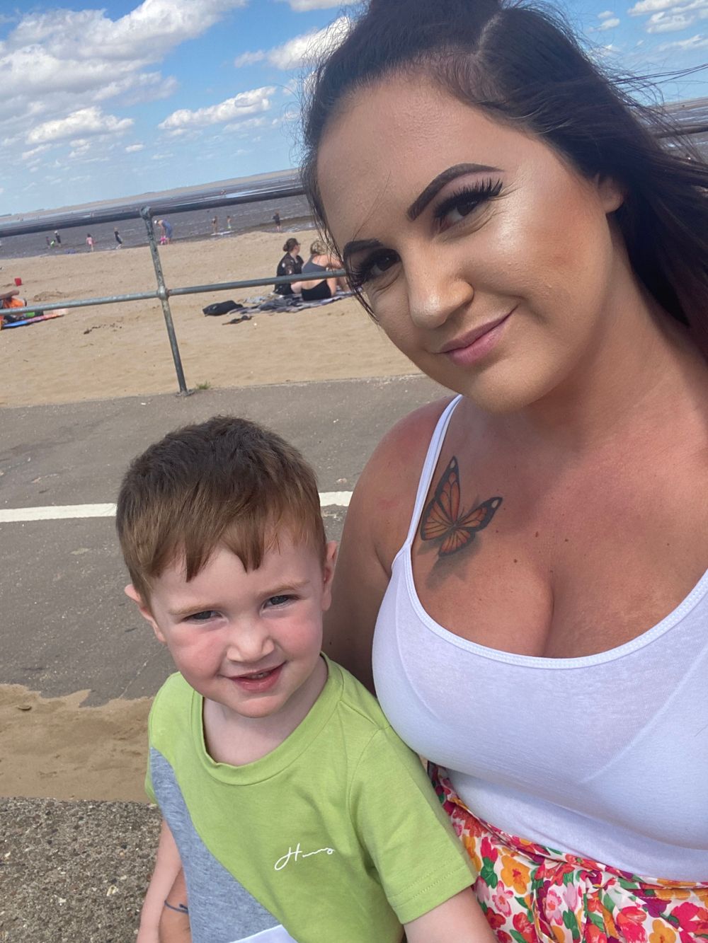 Mother taking a selfie at the beach with young son by photographer in DN7.
