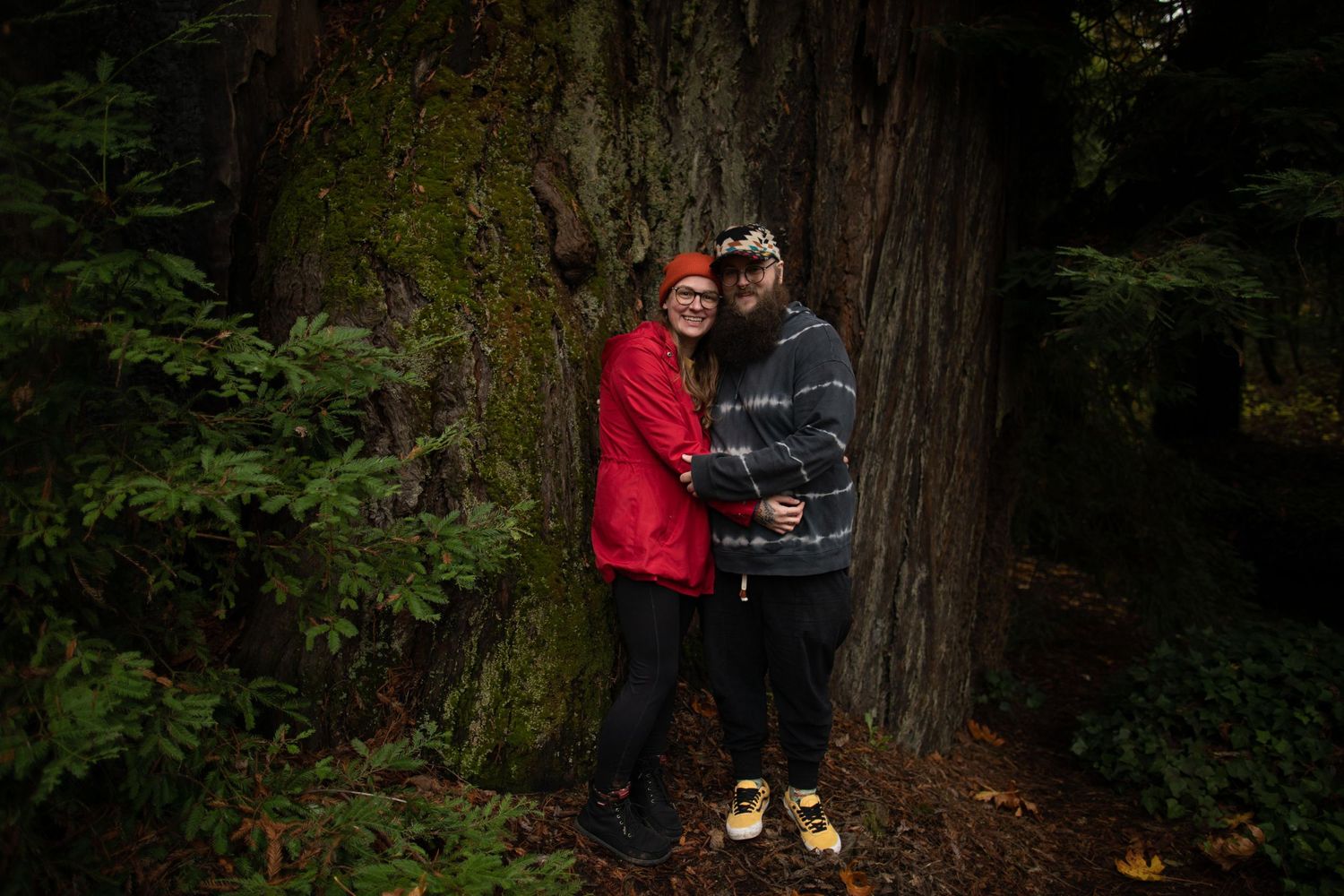 two nonbinary humans embrace kimberly with spouse redwood forest photographer portland oregon