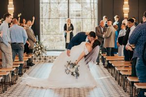 Elegant wedding ceremony in a light-filled chapel with wooden pews and tall windows.