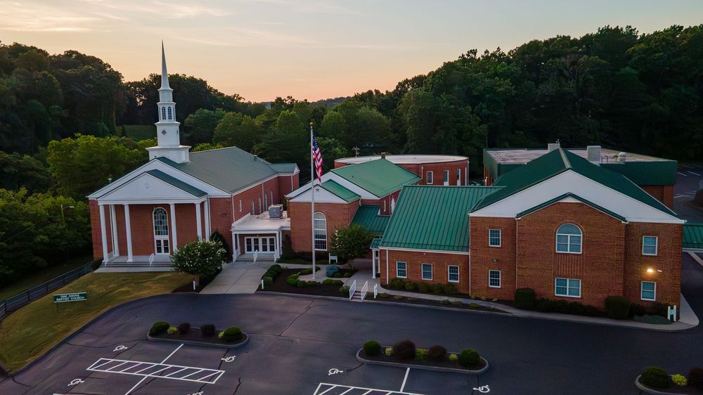 Aerial photo of a church building and parking lot.