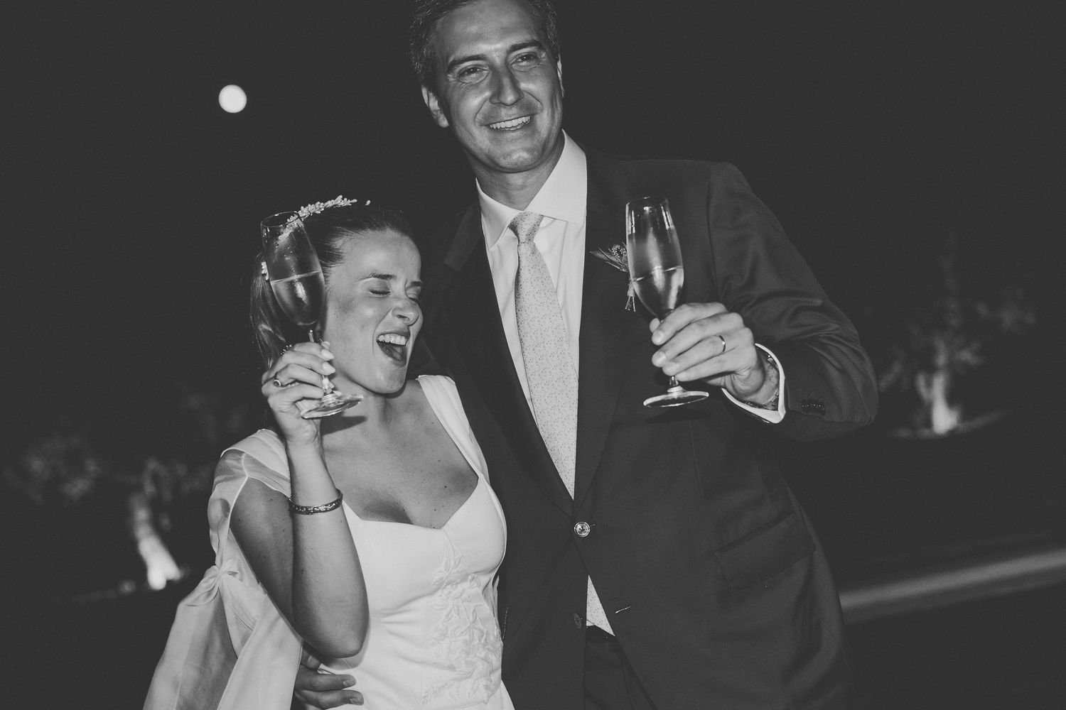 Wedding photography series capturing newlyweds walking through a scenic vineyard at sunset.