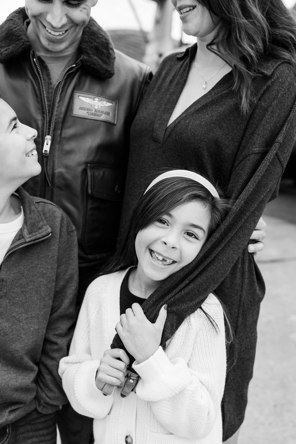 A black and white photo series showing joyful candid moments and genuine smiles between family members.