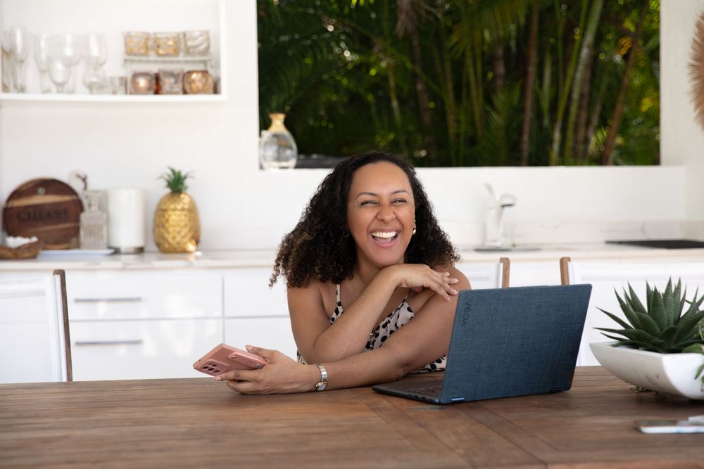 Modern tropical home office setup with laptop and pineapple decor.