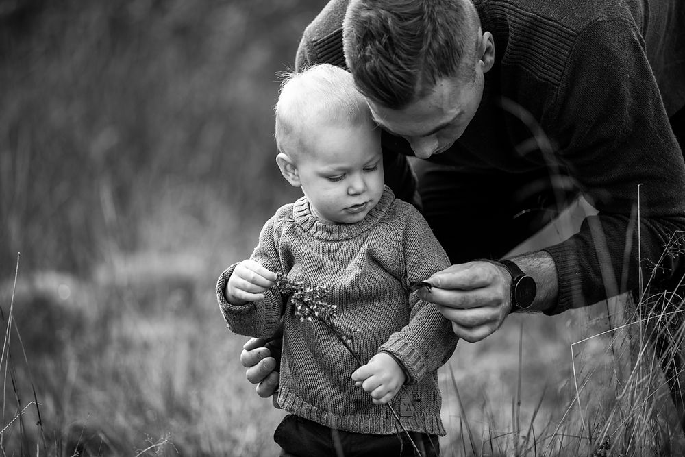 Black and white candid moment of tender interaction in nature.