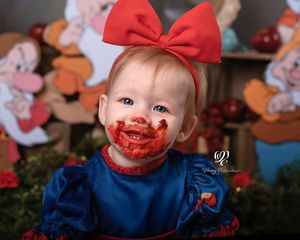 Smiling baby girl first birthday photos Lexington, SC; best photographer Lexington, SC; Snow White photoshoot first birthday apple cake