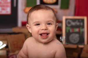 smiling baby boy first birthday photoshoot; pizza cake smash theme birthday session; best professional photographer Lexington, SC