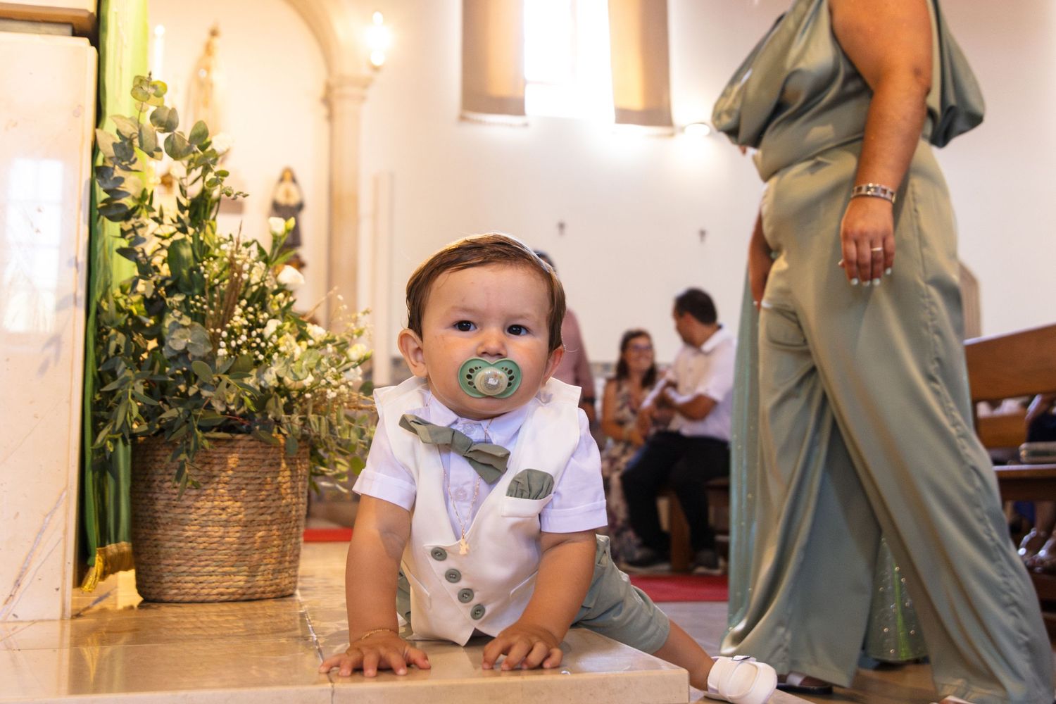 Candid moments captured inside church with decorative tile walls and natural lighting.