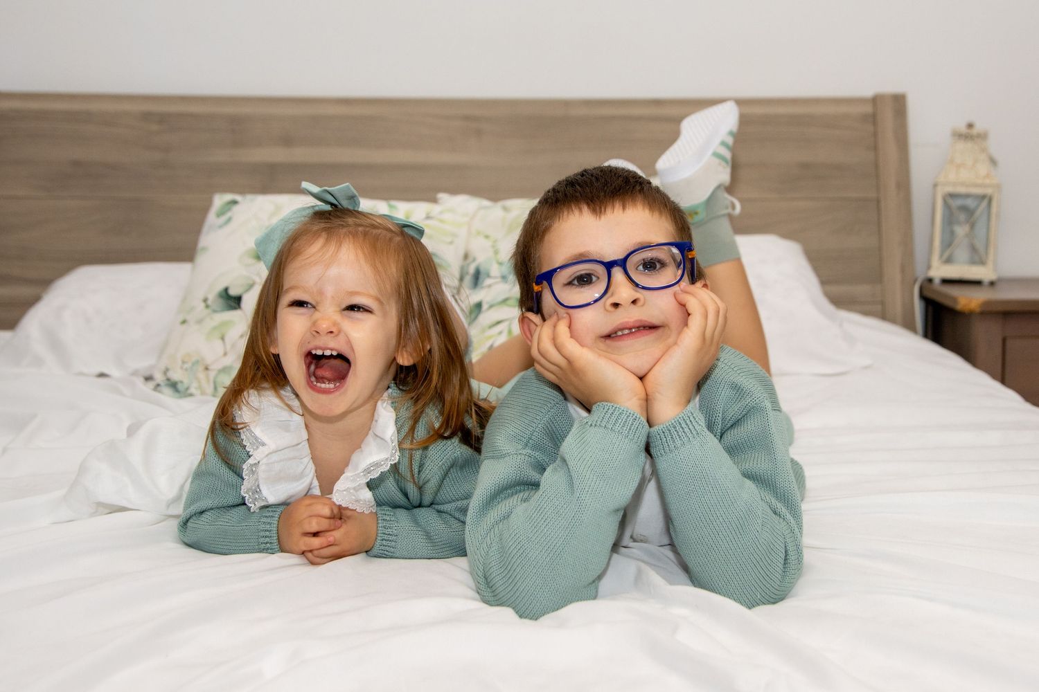 Playful moments shared between family members on a cozy bed.