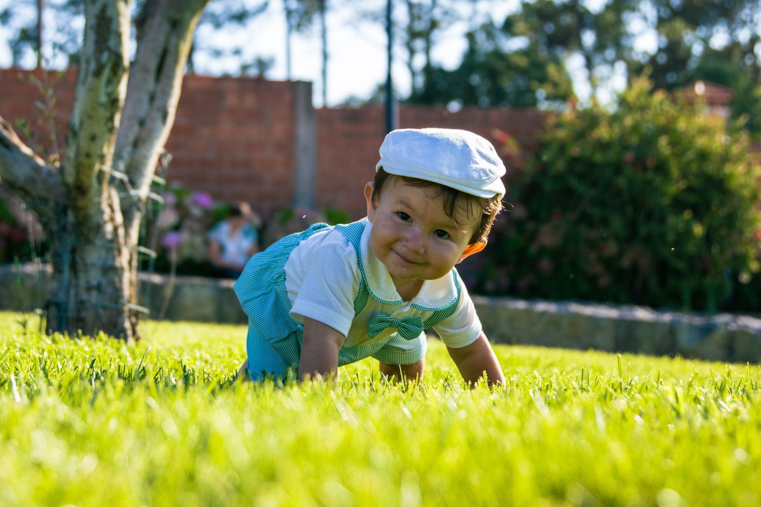 Family relaxing together on lush grass during a sunny afternoon.