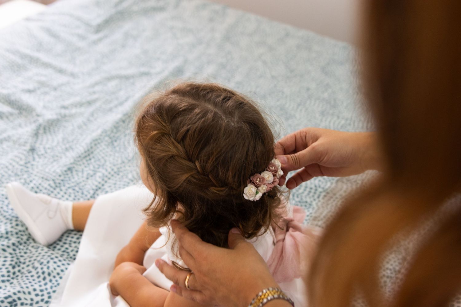 Close-up details of wedding day hair styling and preparation.