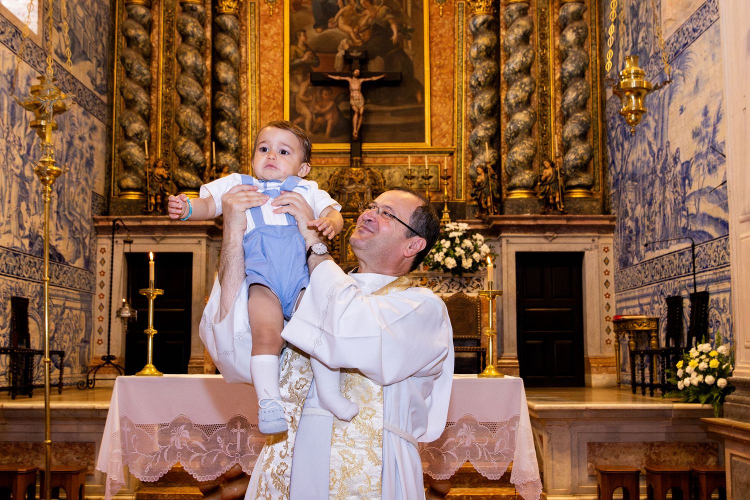 Religious ceremony in ornate church with blue and gold decor.