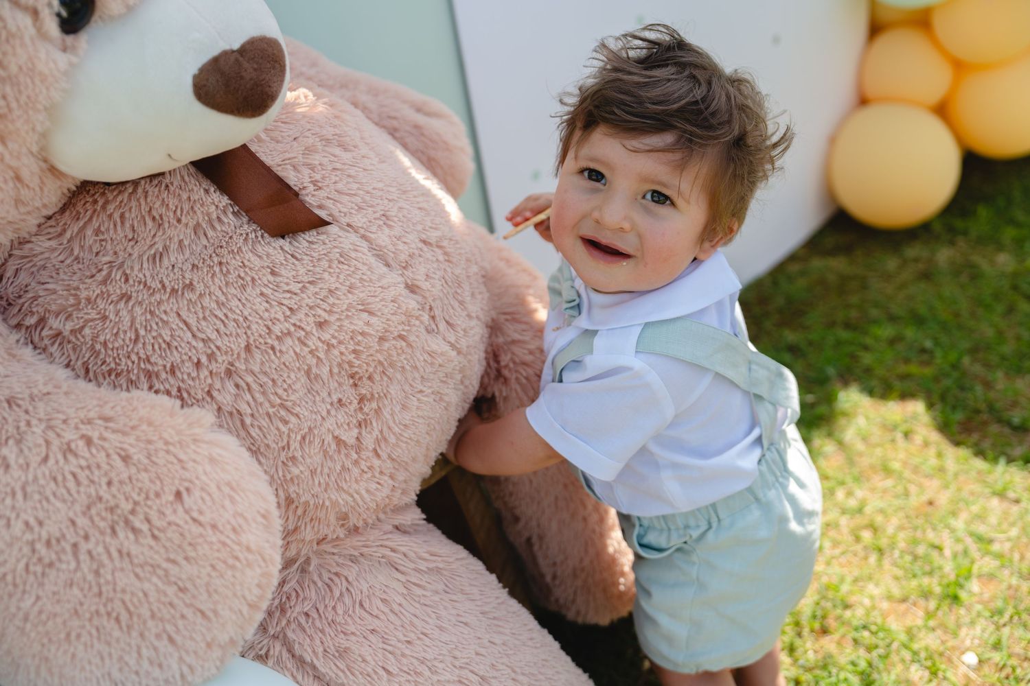 A series of playful moments with a teddy bear and balloons in a sunny outdoor setting.