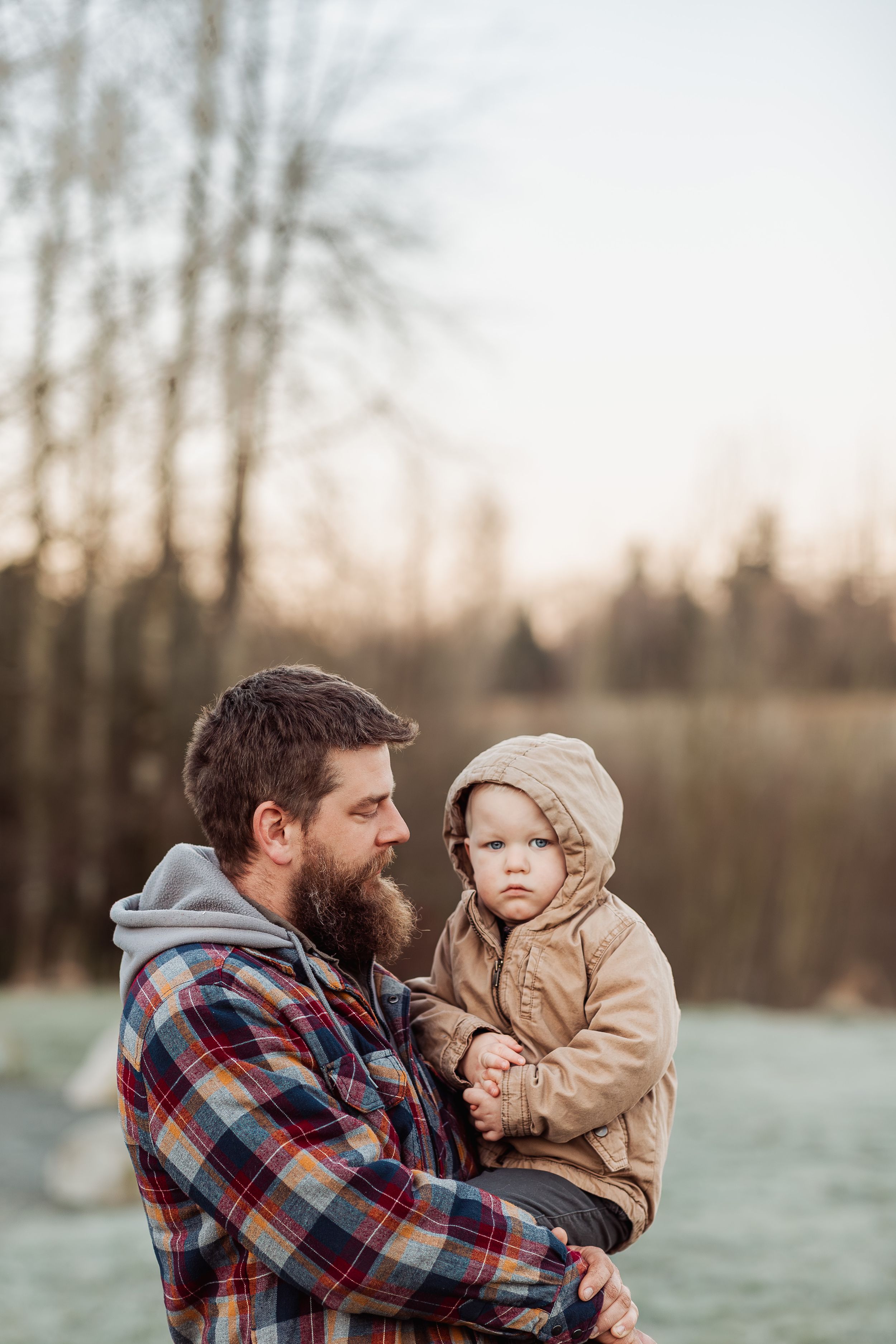 A parent and child share tender moments outdoors during sunrise in a series of candid shots.