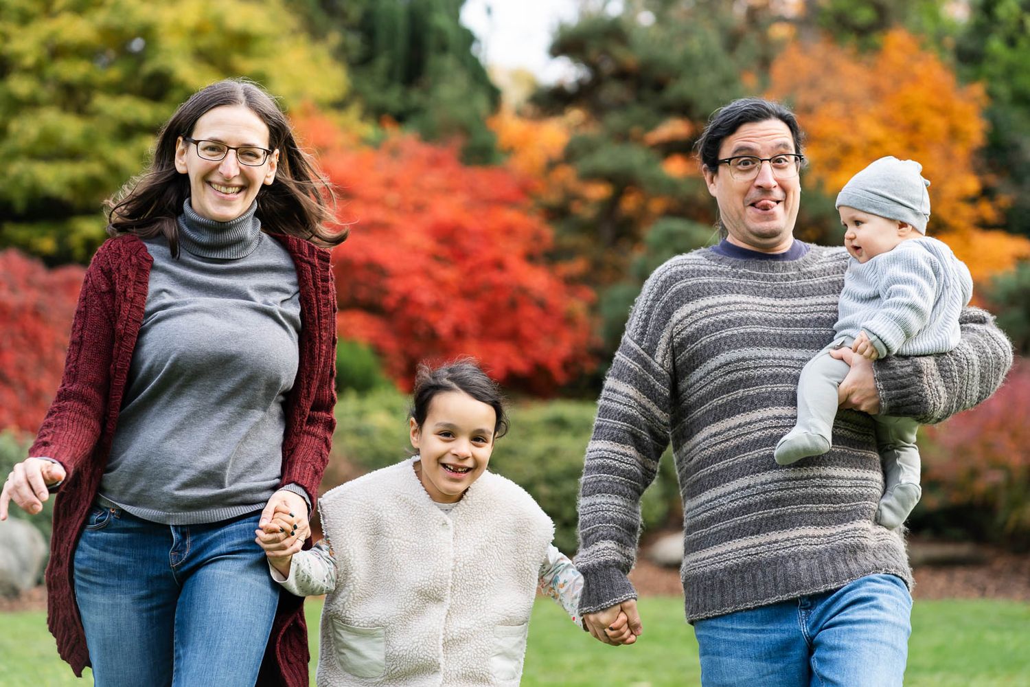 Family running through kubota gardens in the fall