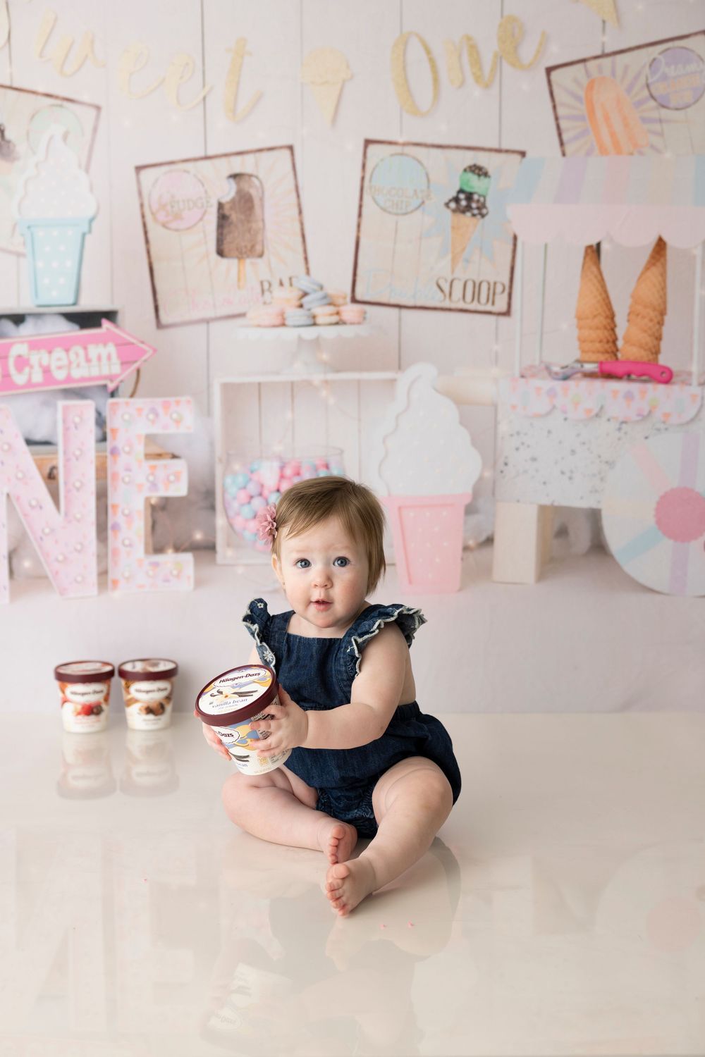 Ice cream themed party setting with cute decorations and pastel pink accents.