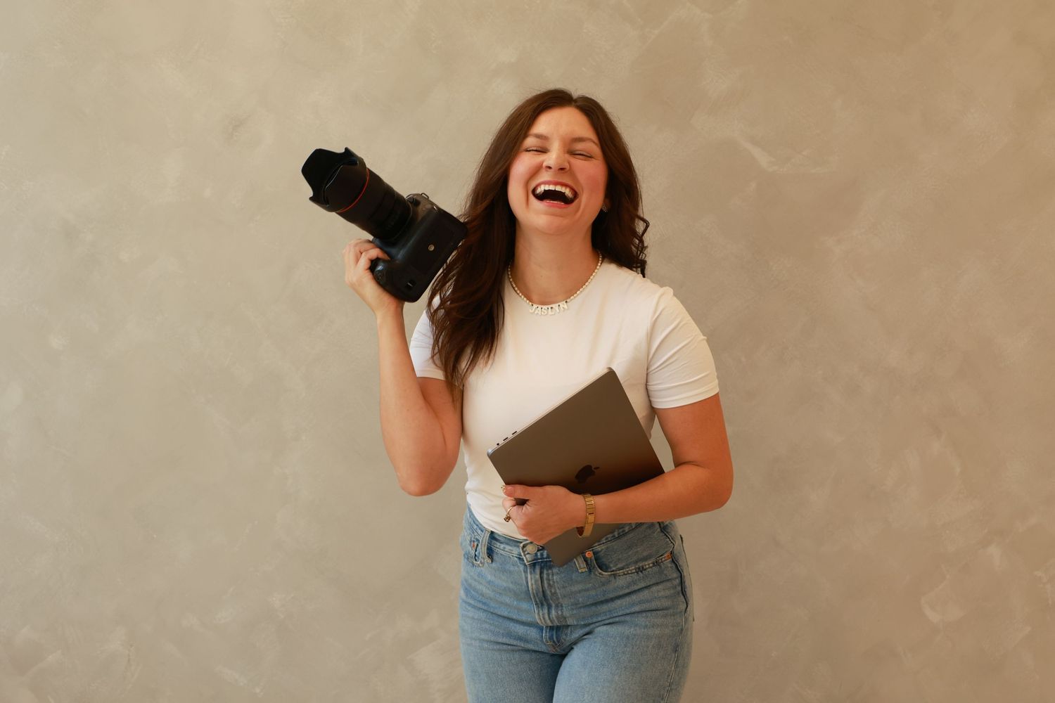 Jaslyn Andrea Creative founder holding a camera