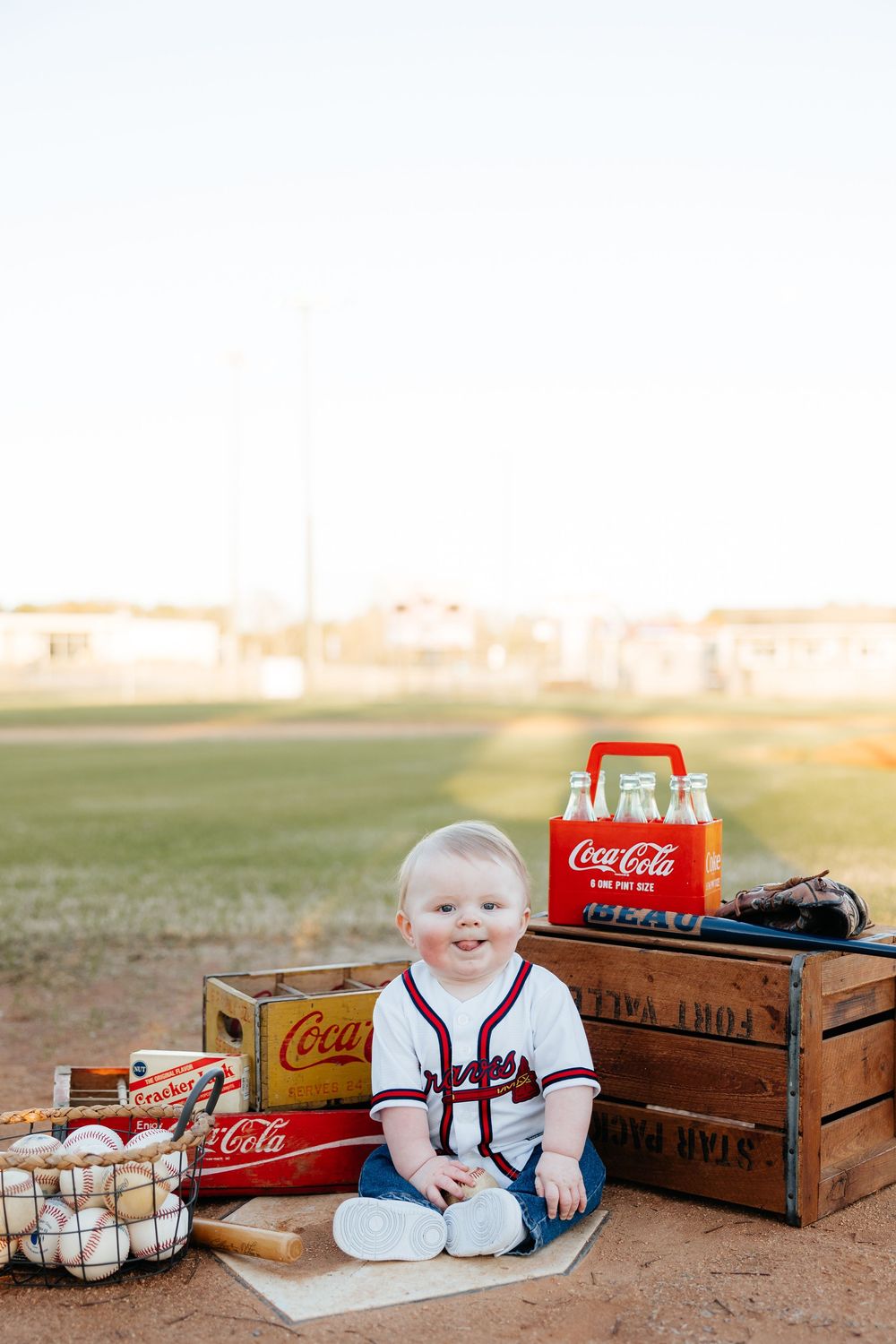 Vintage-styled photo series with wooden Coca-Cola crates and glass bottles arranged in rustic outdoor setting at sunset.
