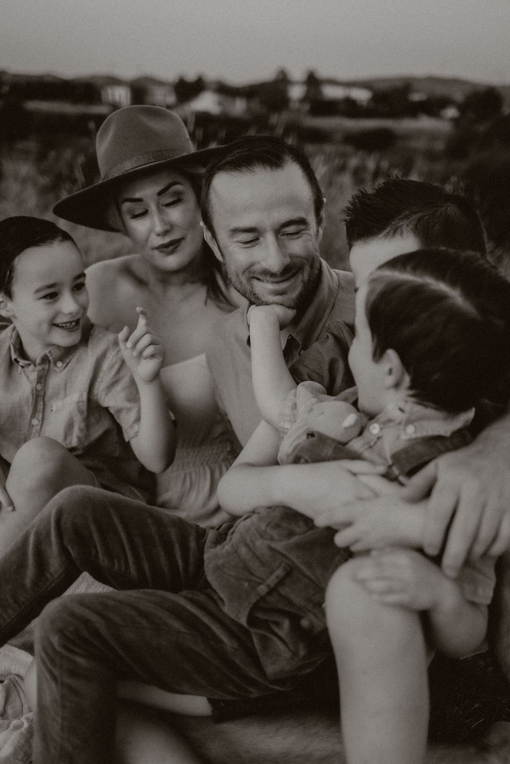 Black and white sequence of intimate moments showing affection and laughter between two people in casual attire.