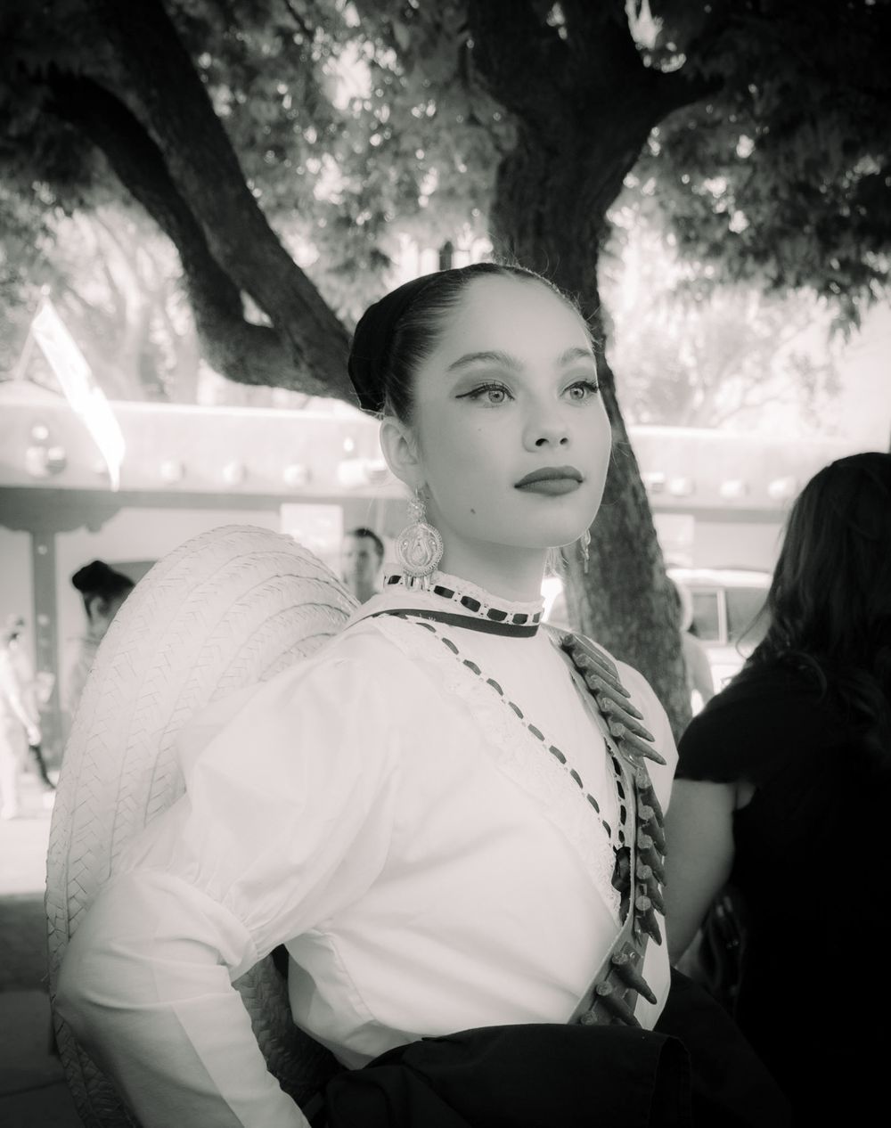 A black and white image series captures a beautiful senorita in a western outfit at a fiesta in historic Santa Fe, NM.