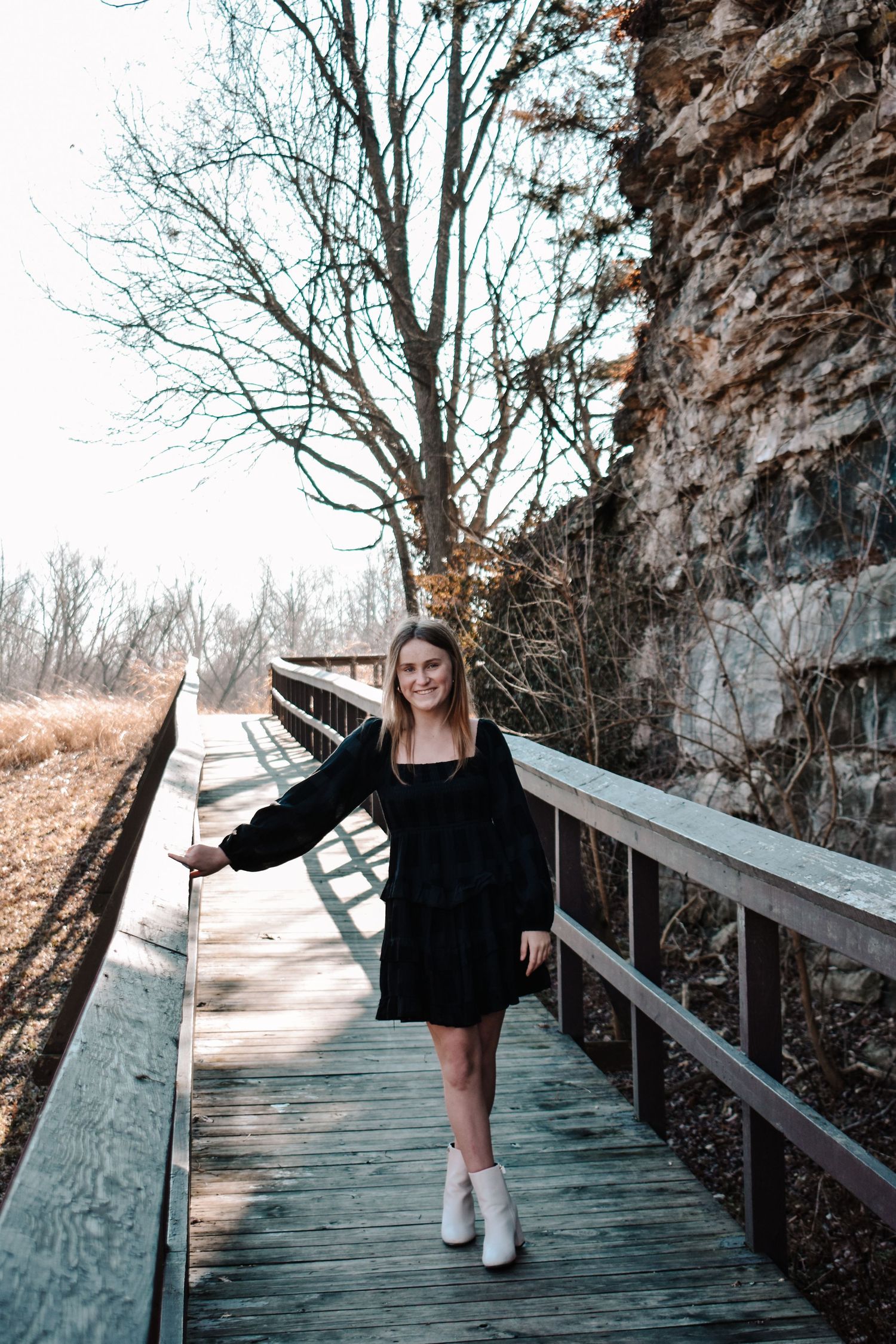 kc senior portrait, loose park bridge with young woman smiling