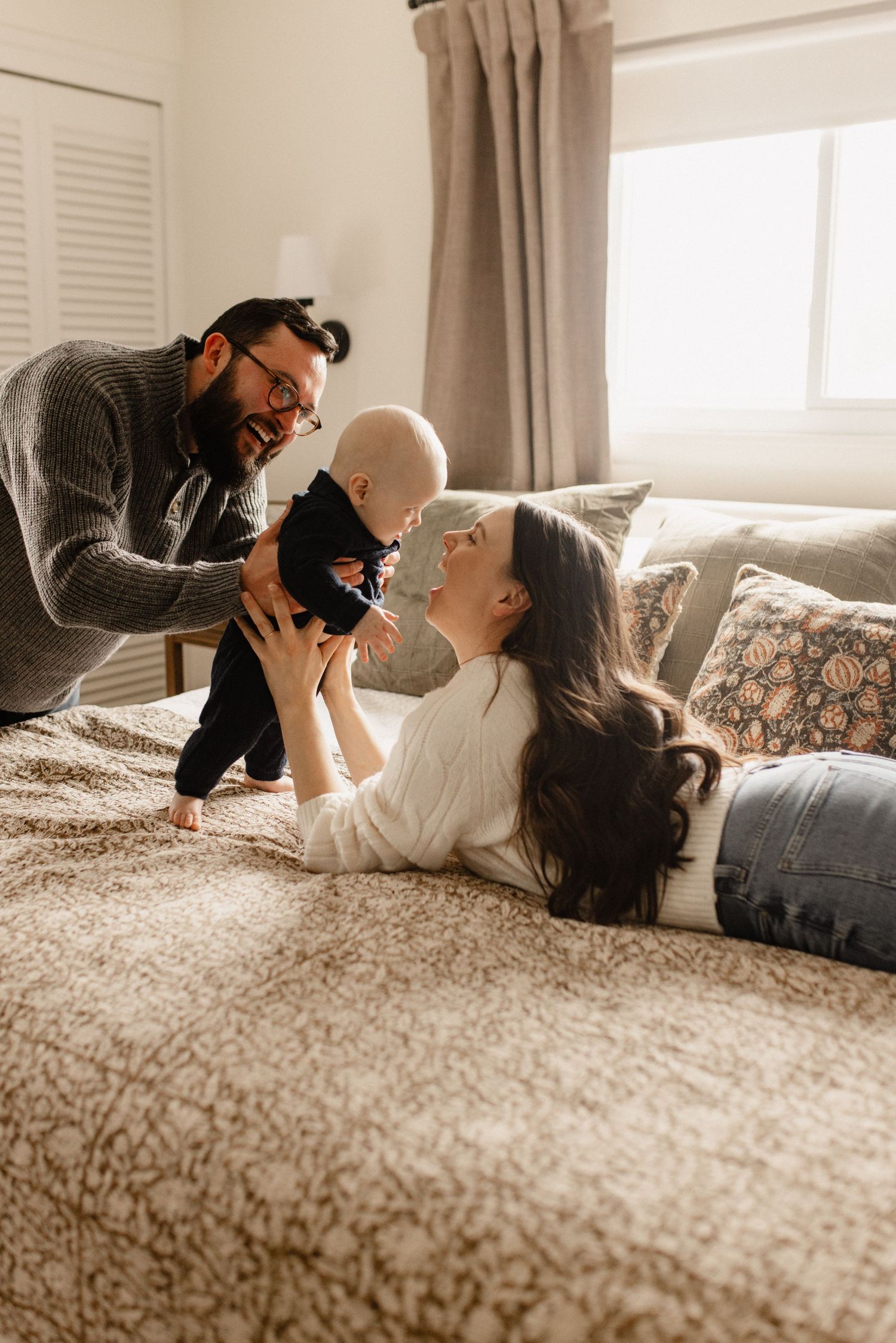 A playful indoor lifestyle photoshoot on a cozy bed.