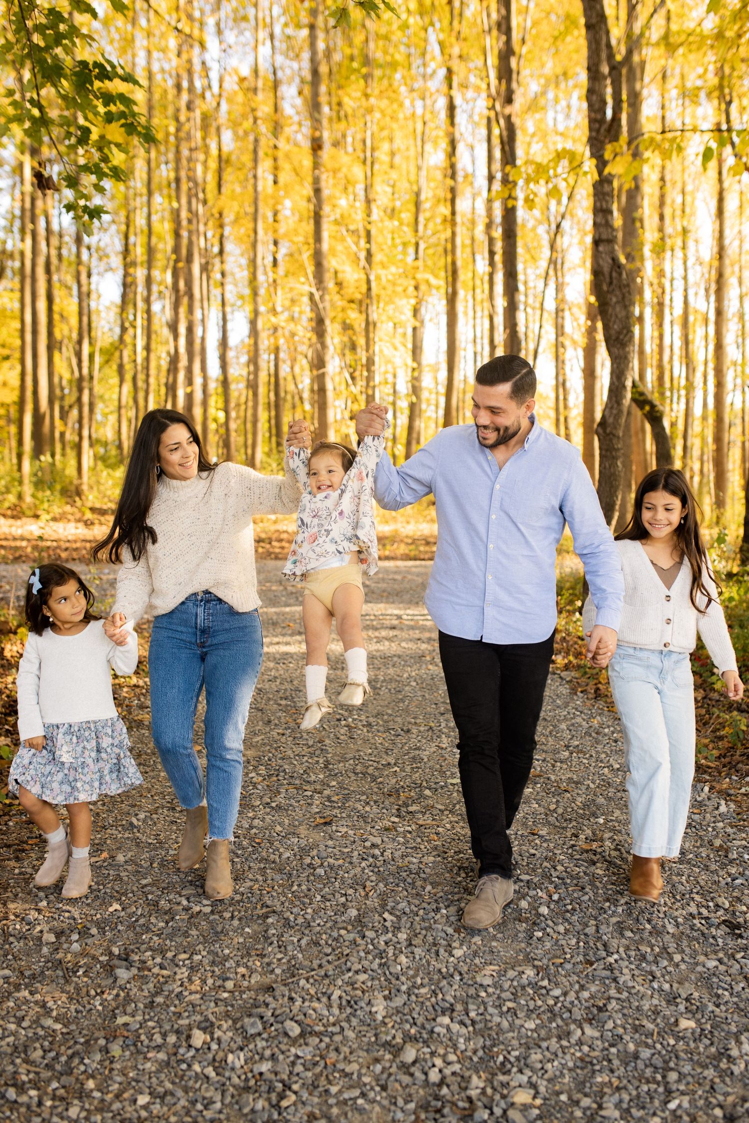 Dc Family holding hands walking in Black Hill Regional Park Boyds, MD.