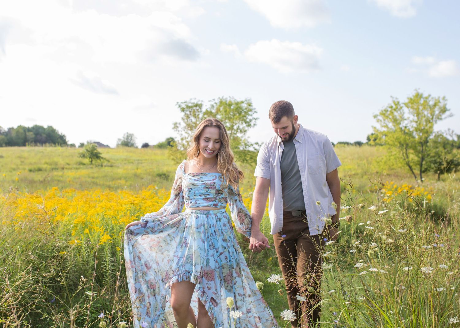 Engagement portrait of a couple in Green Bay WI, showcasing natural smiles and love with a relaxed outdoor setting and soft, romantic light