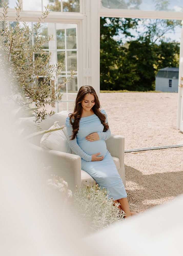 Lovely maternity portraits at Fleurish Greenhouse in Taylorsville, NC.