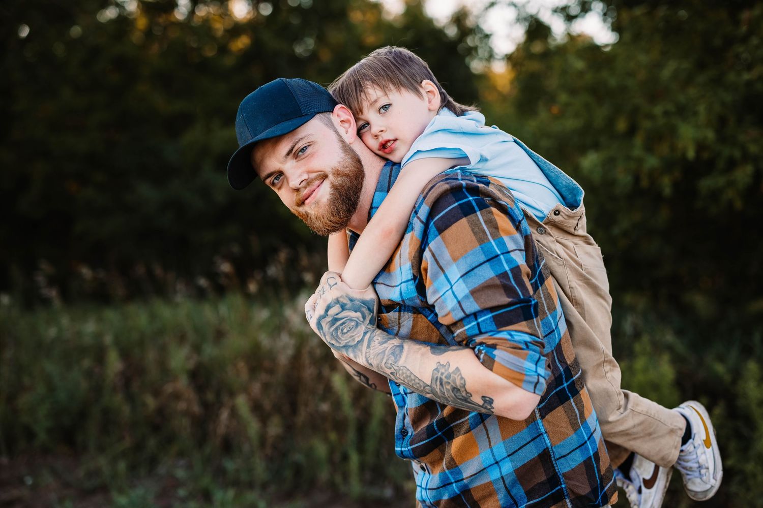 A playful piggyback ride moment captured between two people wearing casual attire outdoors.