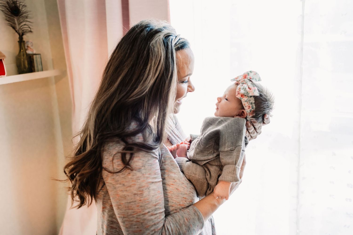 Interior lifestyle photo series showing tender moments between parent and child in natural window light.