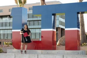 Cora Emilie Media Red and blue geometric architectural installation on university campus with palm trees.
