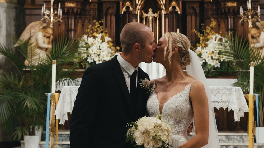 Elegant church wedding ceremony with floral arrangements and candles.