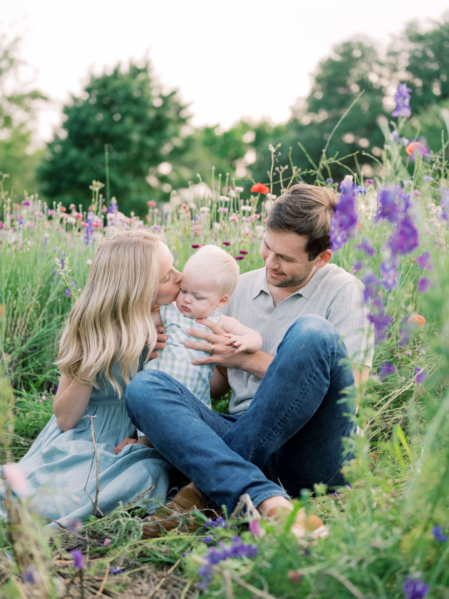 wildflower petite of a mom, dad, and baby boy in the wildflowers