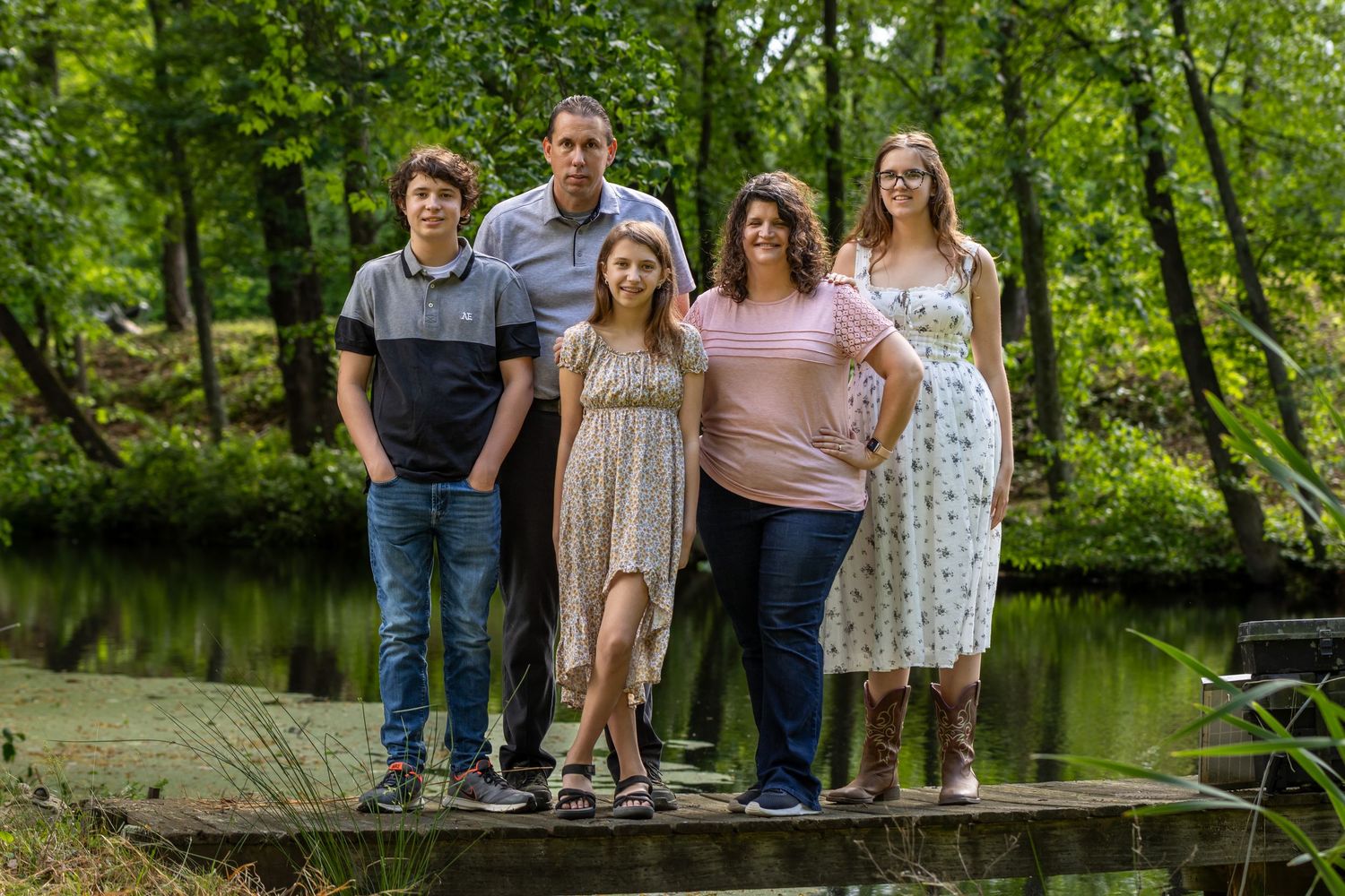 family of 5 on a dock in their backyard with the pond behind them. Salem and Gloucester County Family Photographer