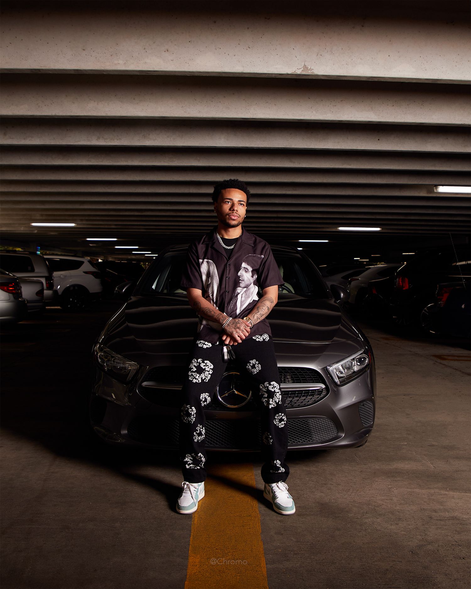 A stylish portrait in a parking garage with yellow arrow and Mercedes-Benz.