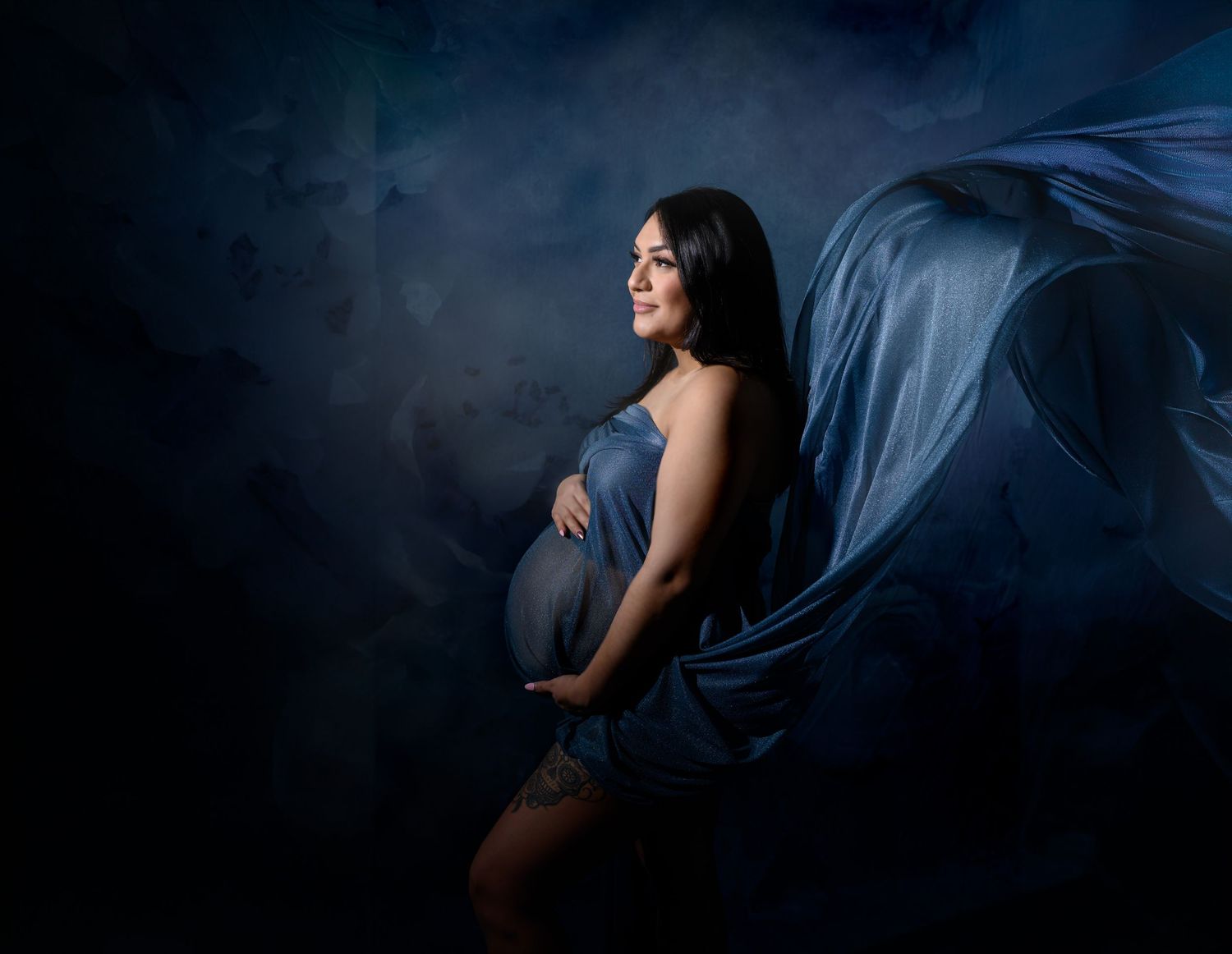 Peaceful newborn sleeping on dark background in artistic portrait style.