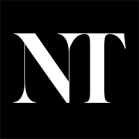 Stylized black and white NT typography logo design on dark background.