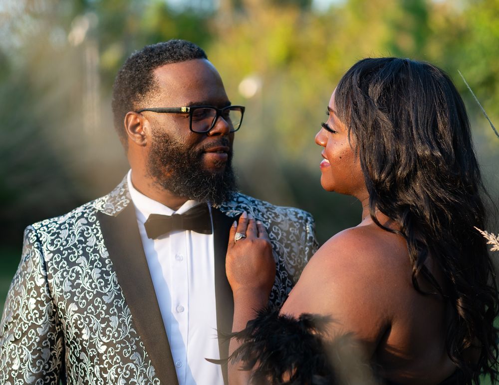 Close-up of couple in formal attire with silver sequined jacket during outdoor photo session.